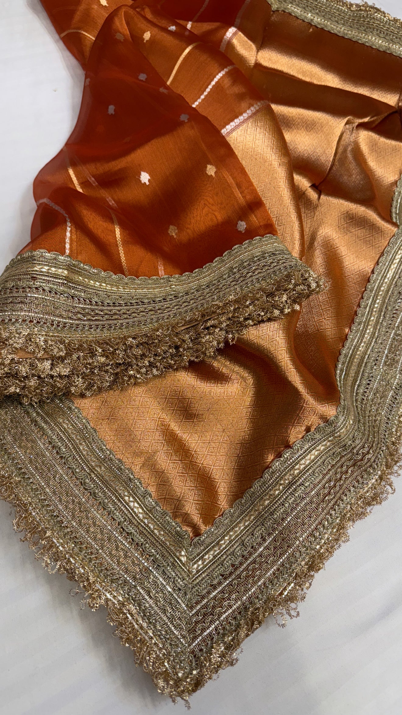 Maharani copperish orange tissue silk kadhwa buti saree