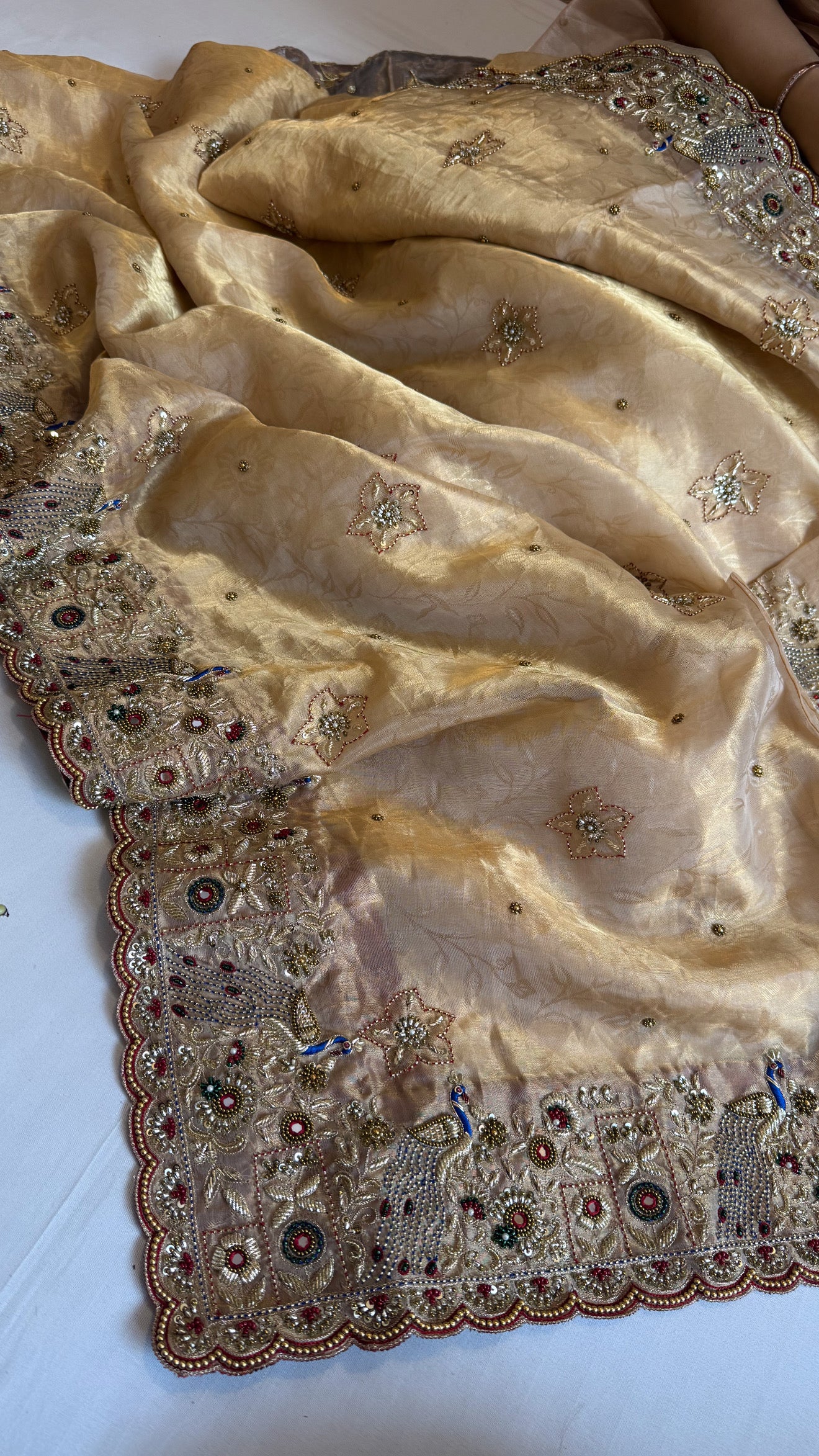 Jadau molten gold tissue silk hand embroidered peacock motif saree