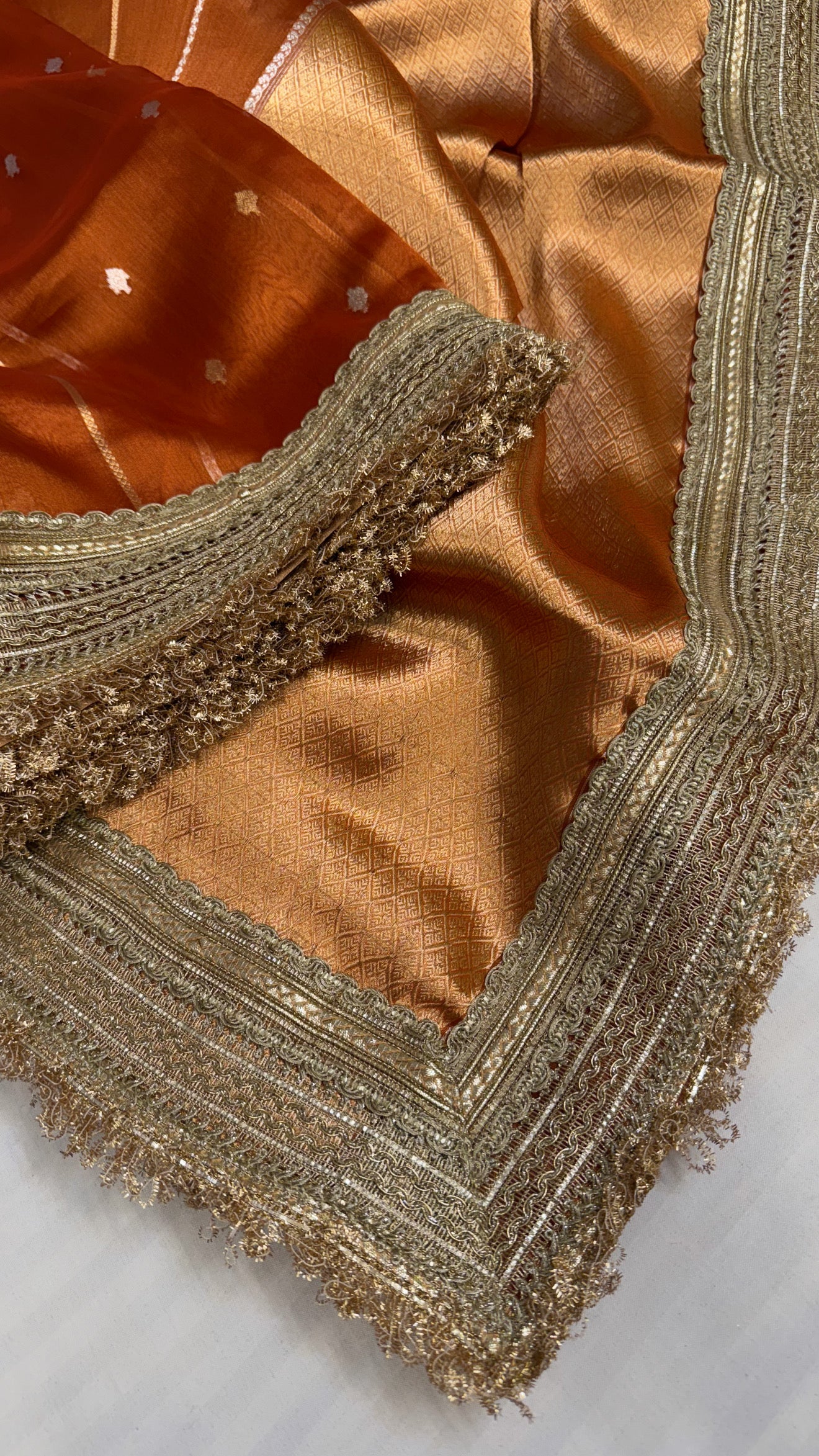 Maharani copperish orange tissue silk kadhwa buti saree