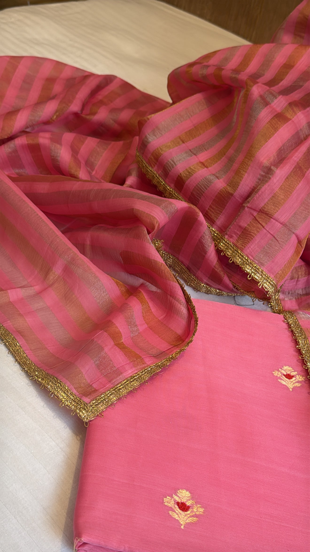 Peachy pink linen gorgette kurta paired with striped tissue silk duppata