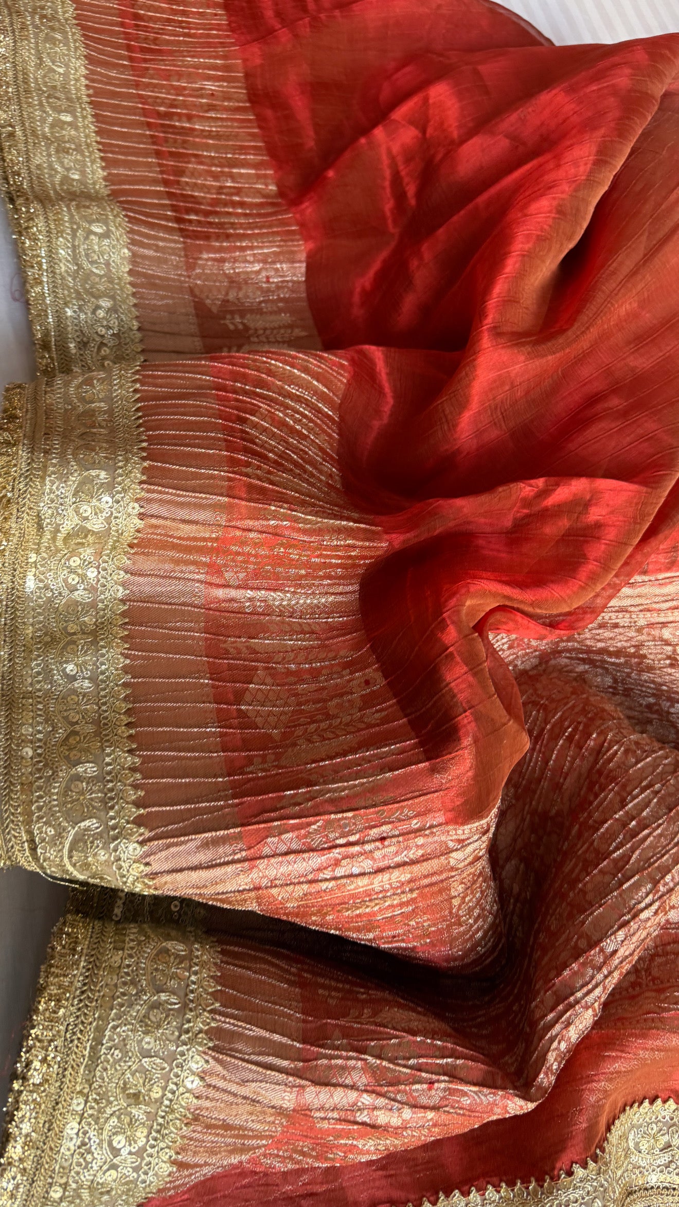 Metallic deep orange dhup chao effect pleated maharani tissue saree