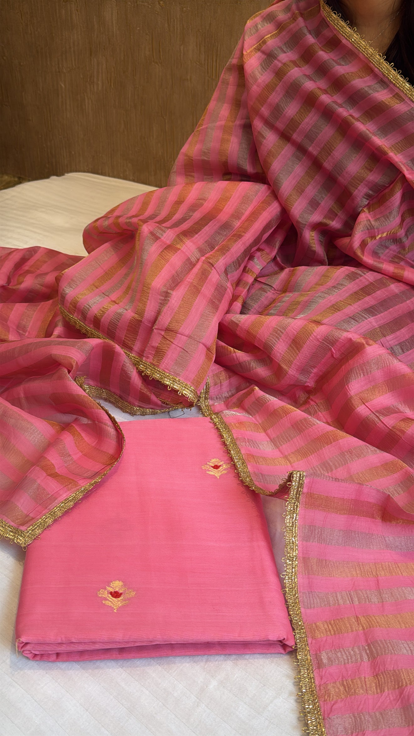 Peachy pink linen gorgette kurta paired with striped tissue silk duppata