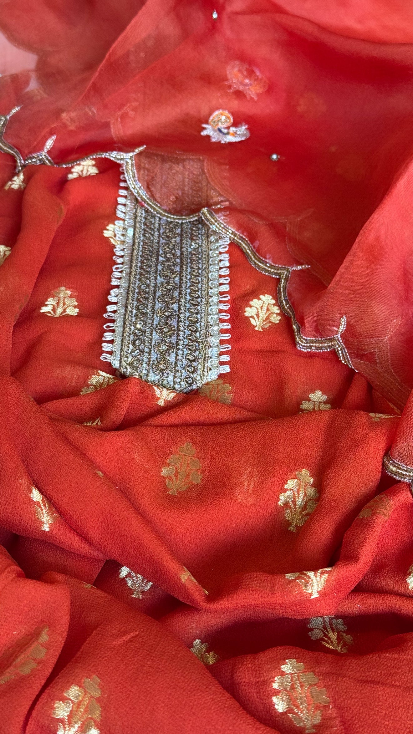Burnt orange banarasi gorgette kadhwa buti kurta paired with toy hathi motif hand embroidered scalloped kora duppata