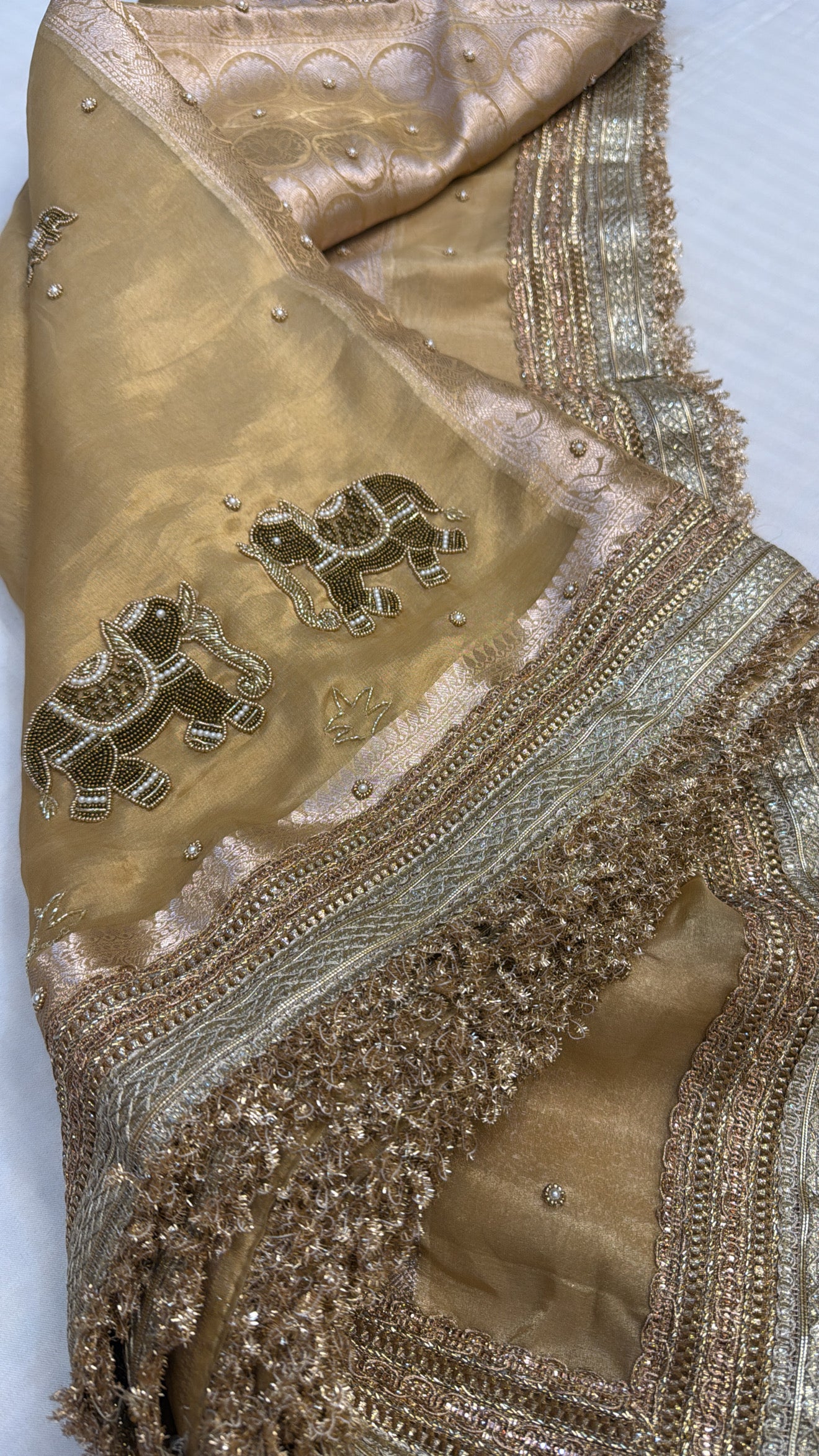 Husn champagne gold tissue silk hand embroidered saree