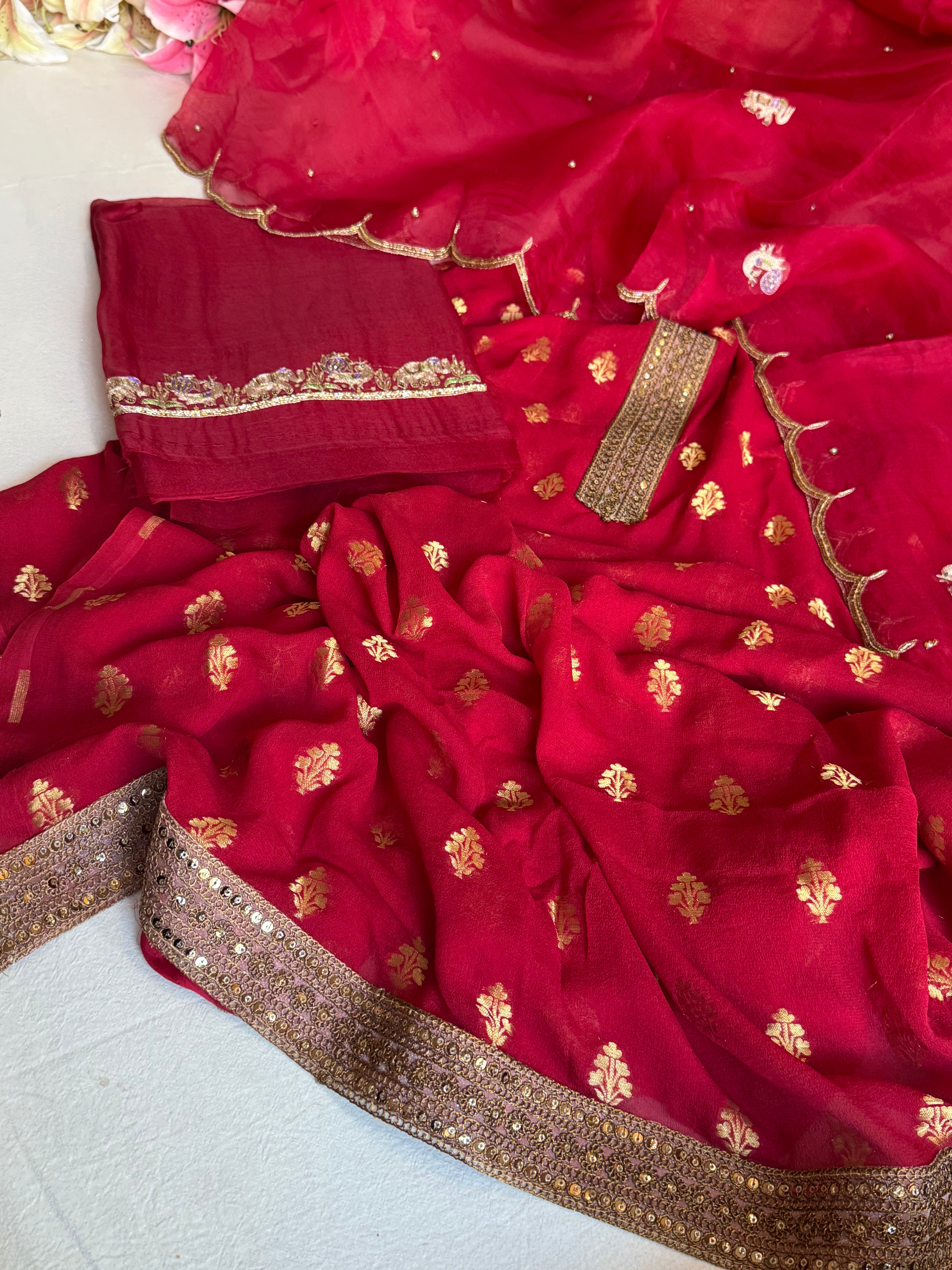 Crimson red banarasi gorgette kadhwa buti kurta paired with toy hathi motif kora silk scalloped duppata set