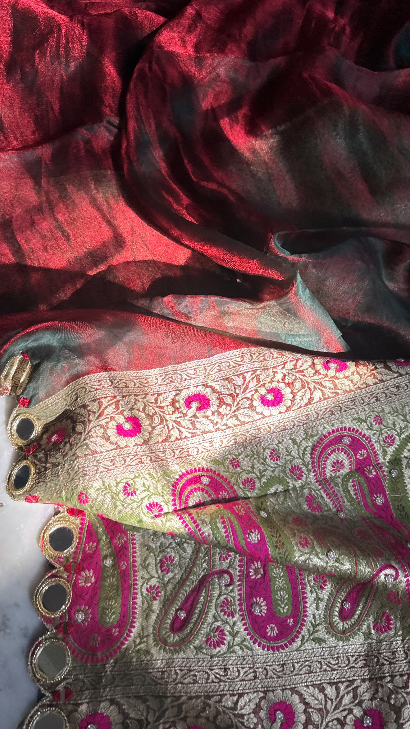 Teej special- Mirror work border maroonish red dhup chao effect tissue silk hand embroidered saree