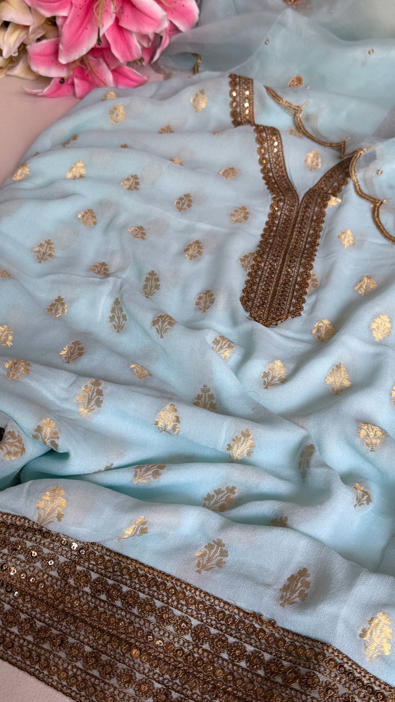 Ice blue banarasi gorgette kadhwa buti kurta paired with toy hathi motif hand embroidered kora duppata