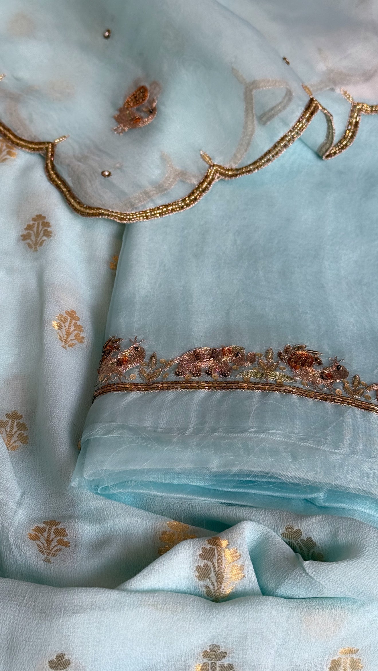 Ice blue banarasi gorgette kadhwa buti kurta paired with toy hathi motif hand embroidered kora duppata