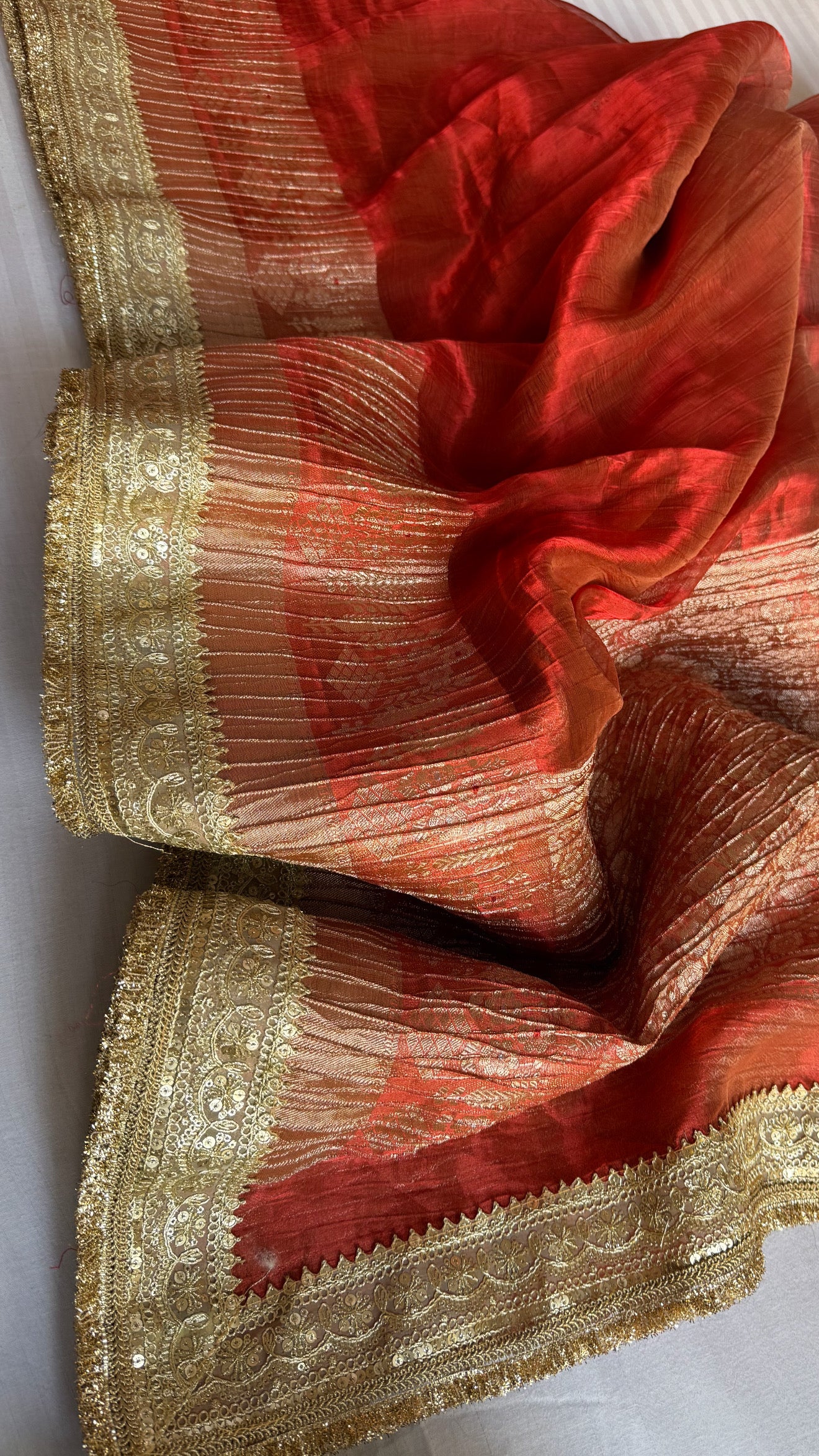 Metallic deep orange dhup chao effect pleated maharani tissue saree