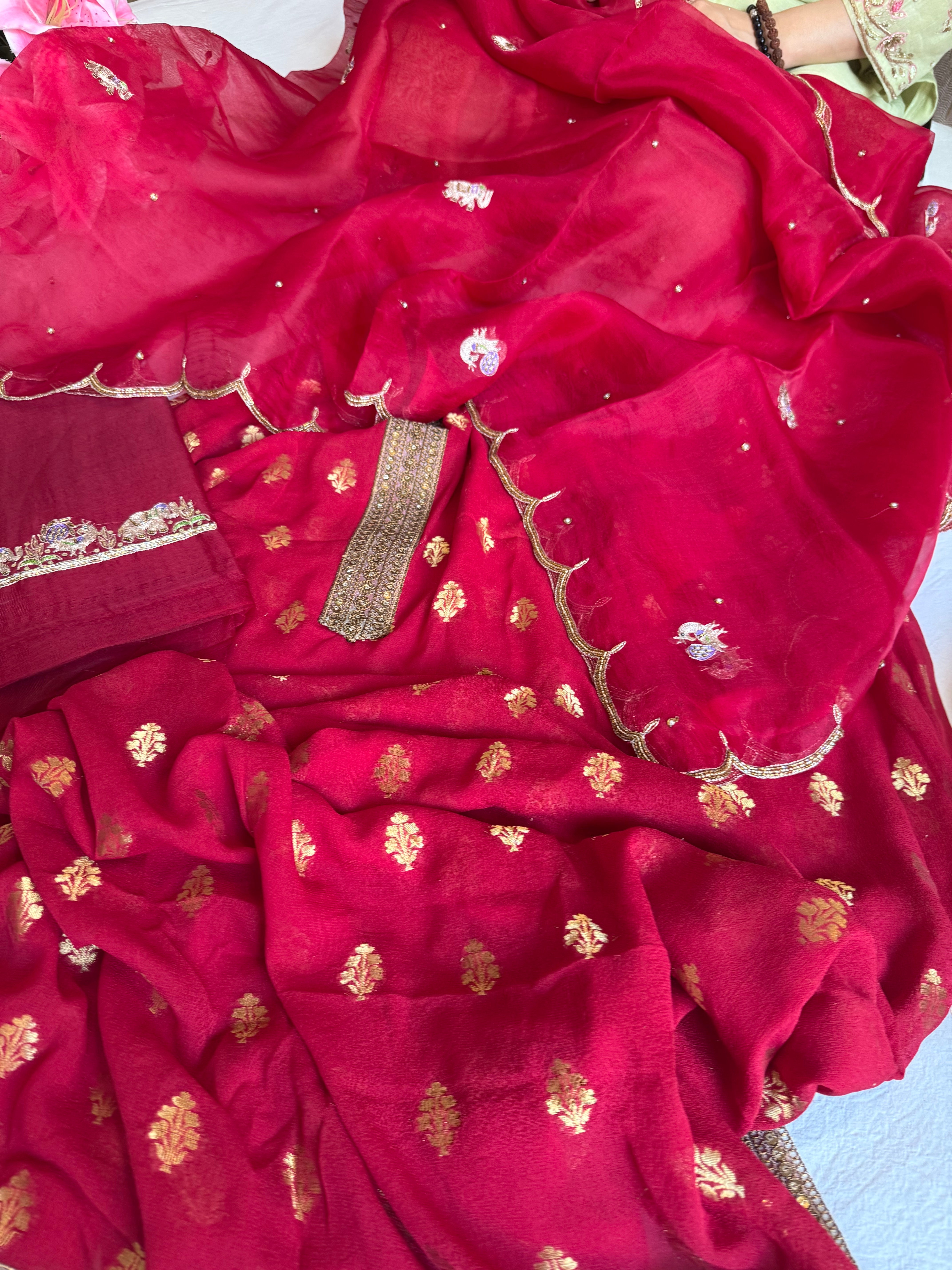 Crimson red banarasi gorgette kadhwa buti kurta paired with toy hathi motif kora silk scalloped duppata set