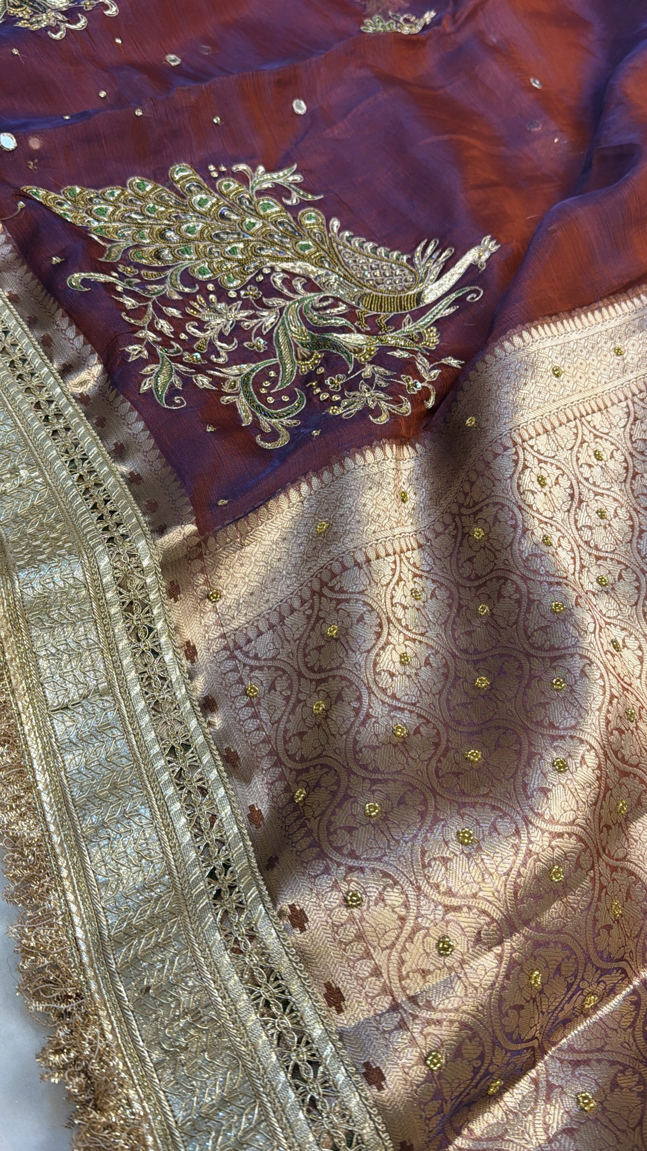 Maroonish-blue dhup chao effect tissue silk peacock motif hand embroidered saree