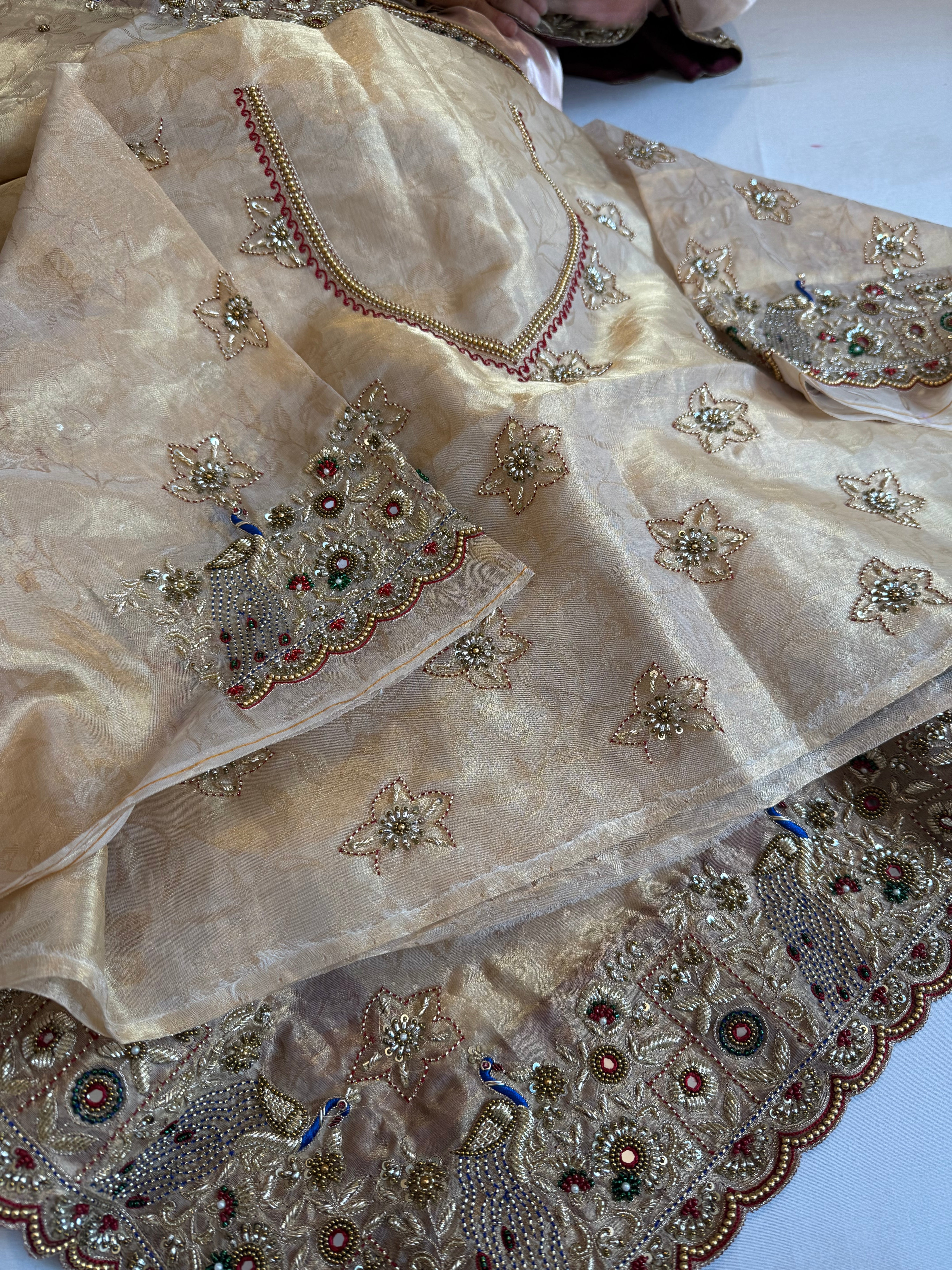 Jadau molten gold tissue silk hand embroidered peacock motif saree