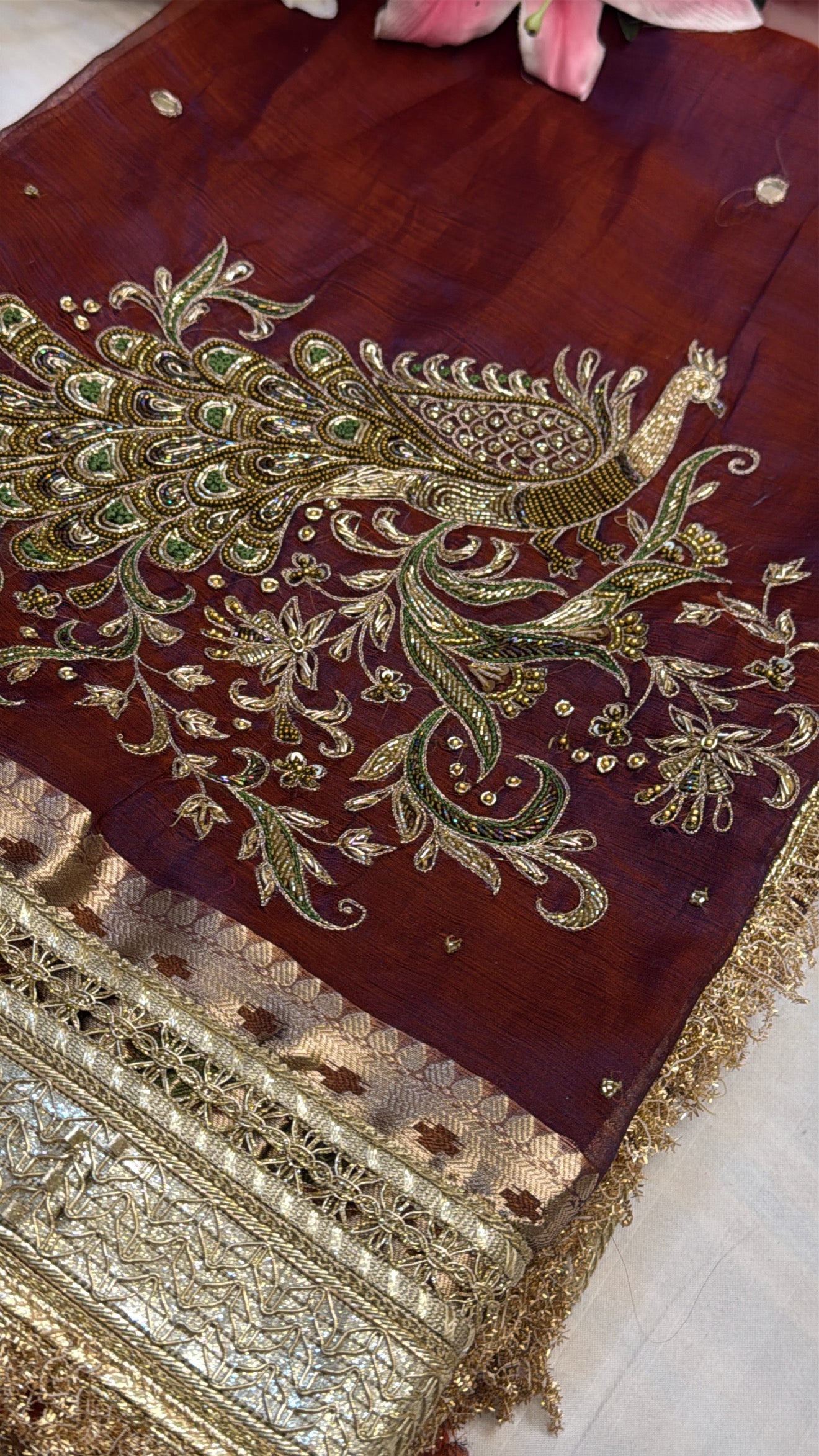 Maroonish-blue dhup chao effect tissue silk peacock motif hand embroidered saree