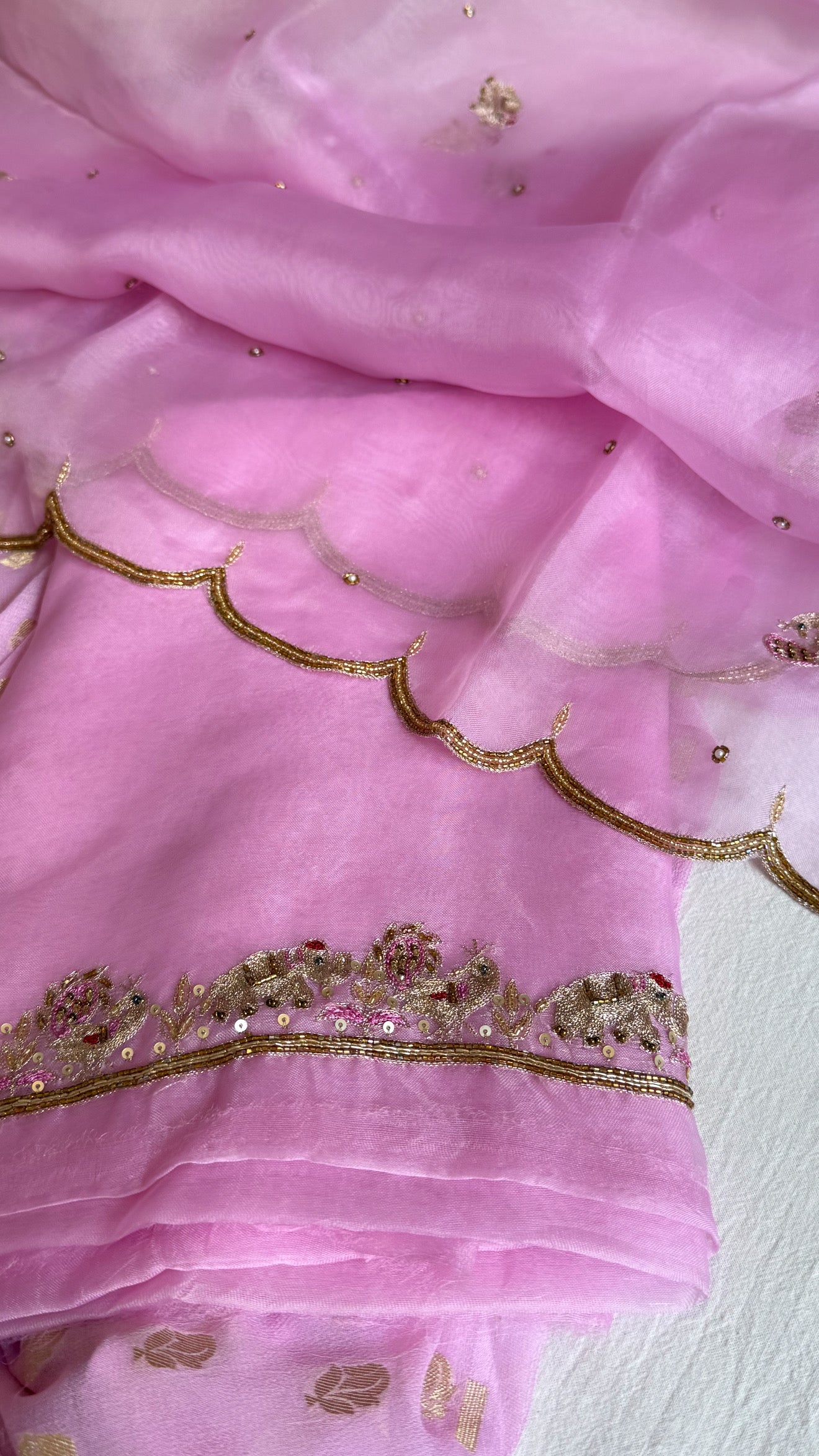 Blush pink banarasi gorgette kadhwa buti kurta paired with toy hathi motif hand embroidered scalloped kora duppata