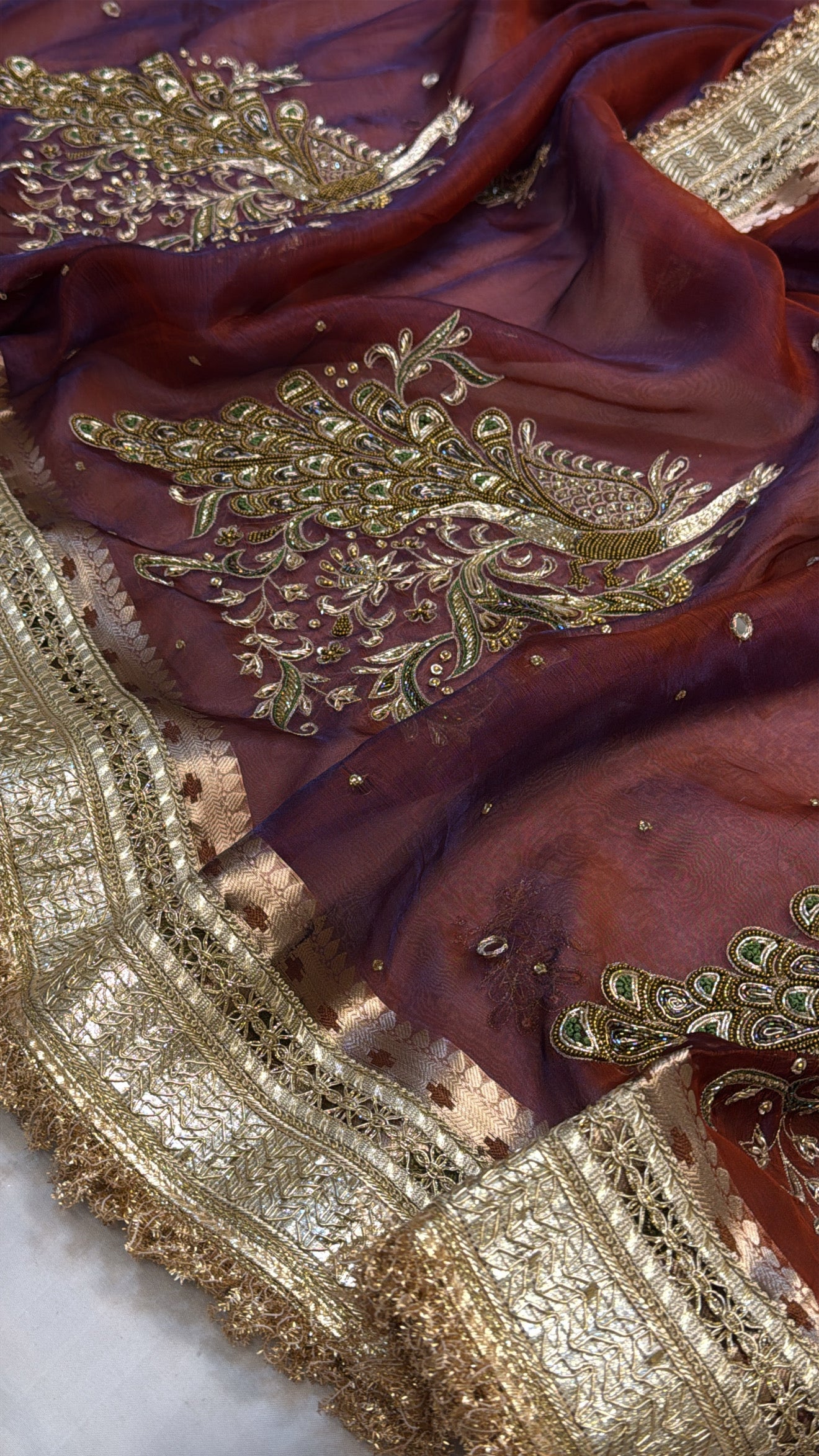 Maroonish-blue dhup chao effect tissue silk peacock motif hand embroidered saree