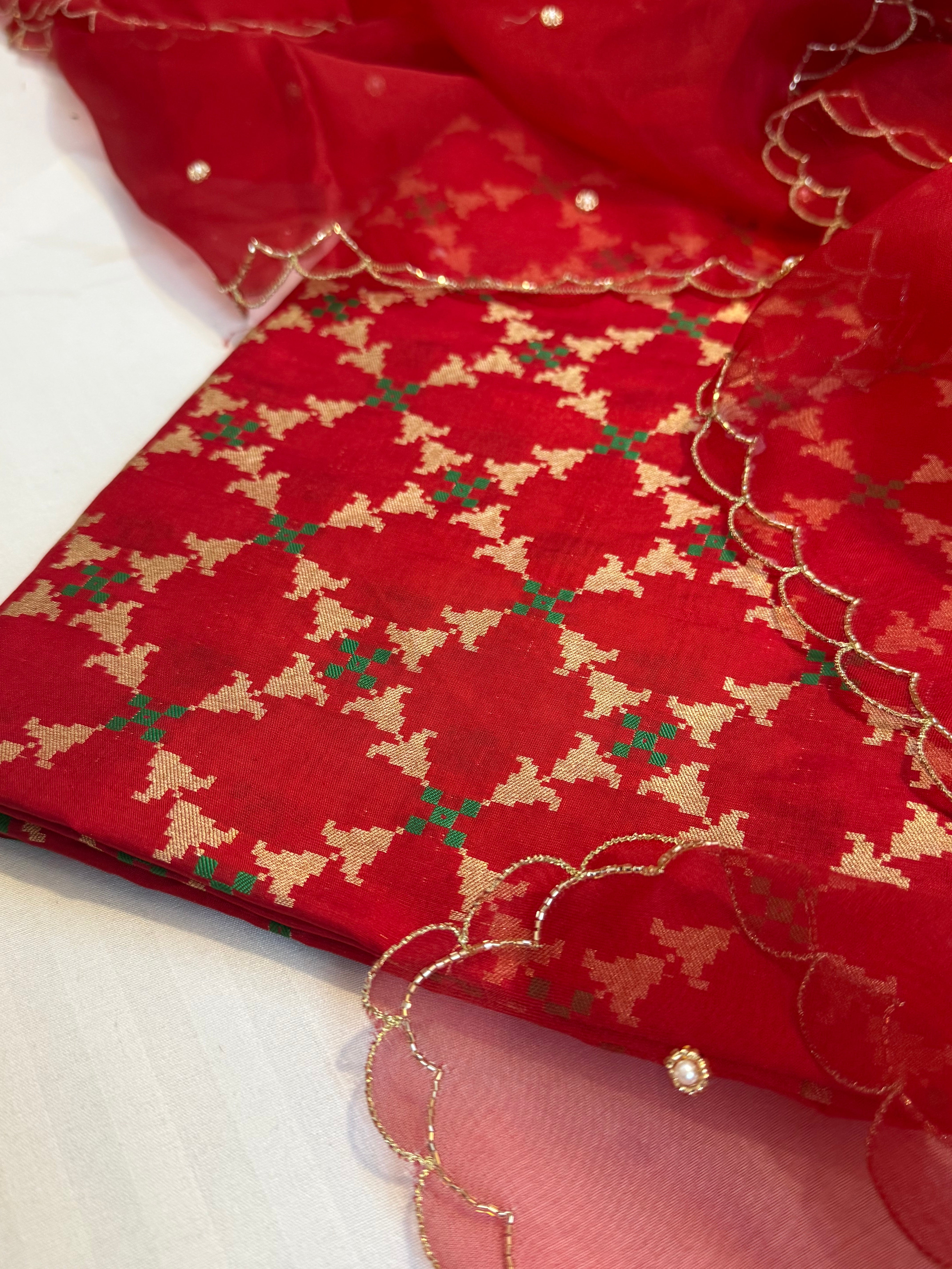 Blood red katan silk patola weaving kurta paired with kora silk scalloped duppata set